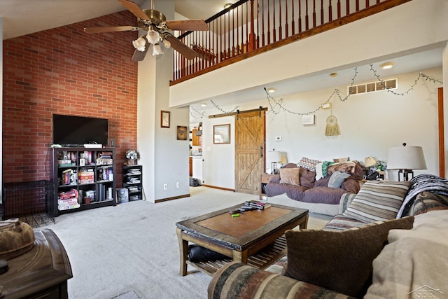 living room with baseboards, carpet, a barn door, high vaulted ceiling, and a ceiling fan