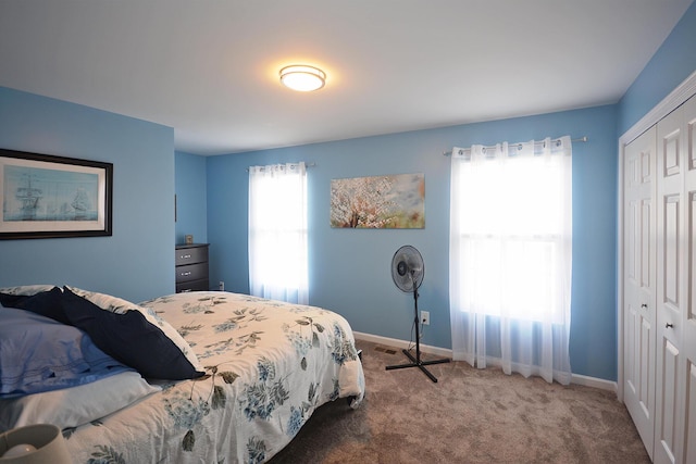 bedroom with a closet, carpet flooring, and baseboards