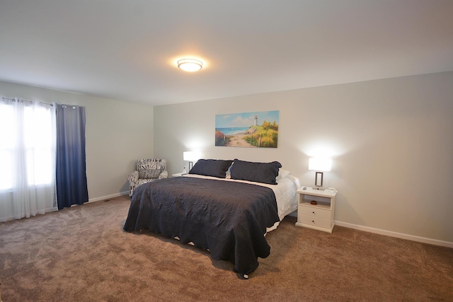 carpeted bedroom featuring baseboards