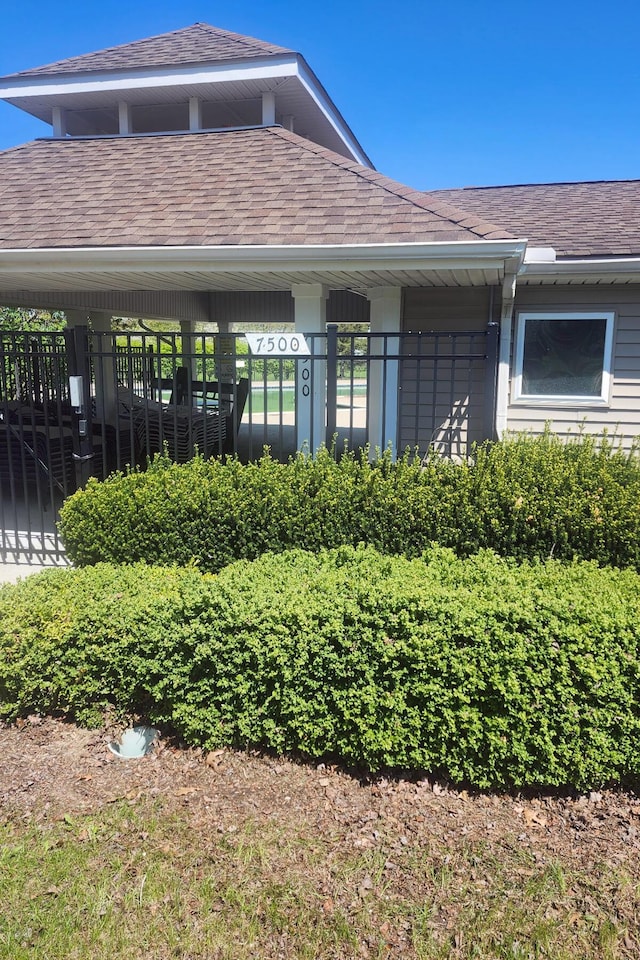 property entrance with roof with shingles