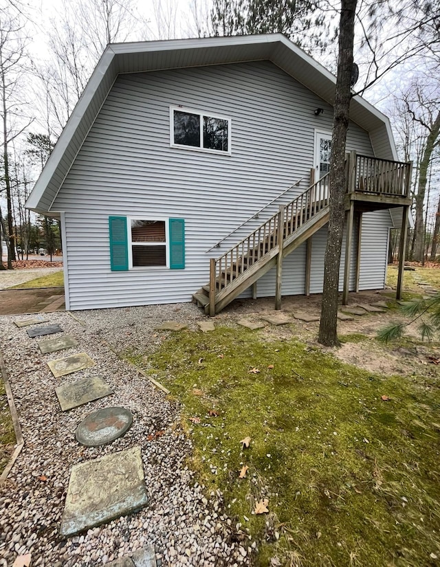 rear view of house with stairway and a deck