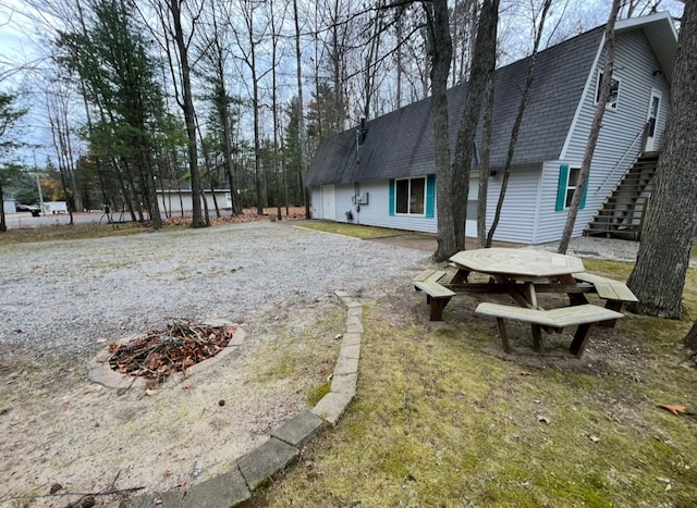 view of yard with a fire pit and stairs