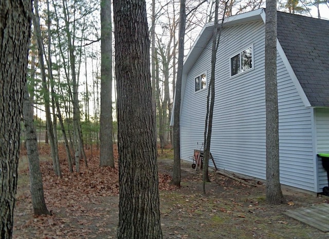 exterior space featuring a shingled roof