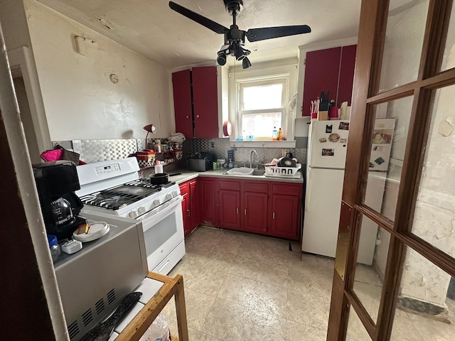 kitchen with decorative backsplash, white appliances, light countertops, and a sink