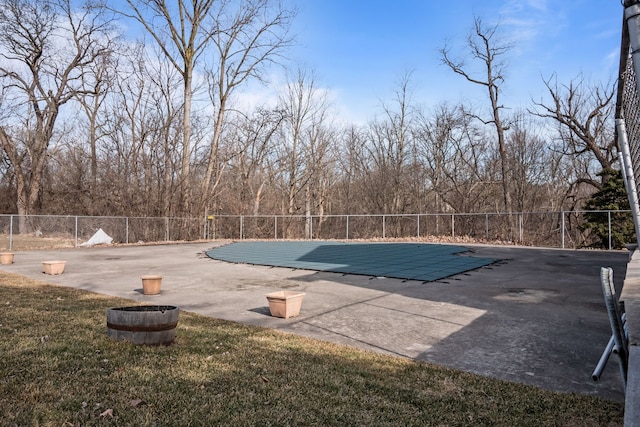 view of swimming pool featuring a fenced in pool, a patio, and fence