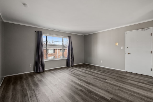 empty room with baseboards, dark wood-style floors, and crown molding