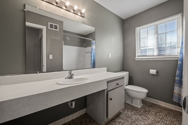 full bath with vanity, baseboards, visible vents, tile patterned floors, and toilet