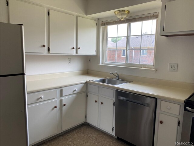 25331 Shiawassee Cir Unit 206, Southfield, MI 48033 - kitchen with stainless steel appliances, a sink, light countertops, white cabinets, and dark tile patterned floors