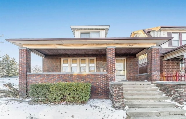 view of front of property with brick siding and a porch