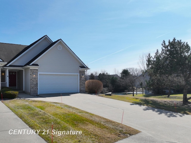 view of front of property featuring brick siding, driveway, and a garage