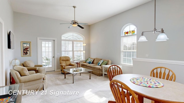 living area with light carpet, a ceiling fan, and a wealth of natural light