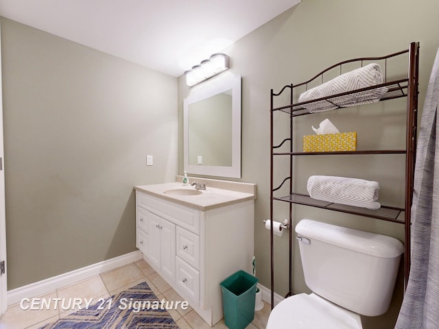 bathroom with tile patterned floors, baseboards, toilet, and vanity