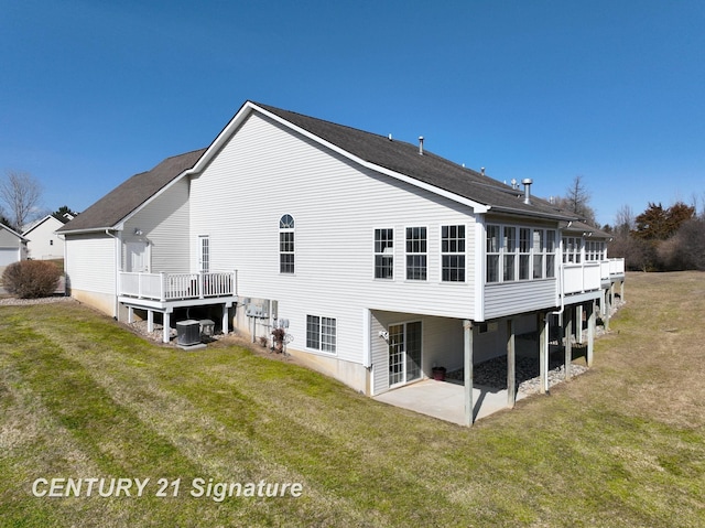 back of house featuring cooling unit, a patio, a yard, and a sunroom