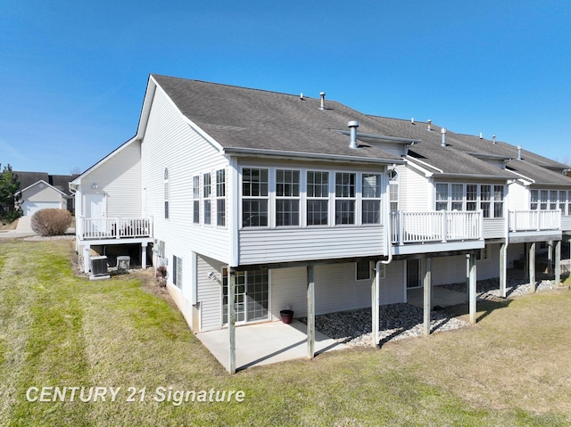 back of house with a patio area, central air condition unit, a lawn, and a wooden deck