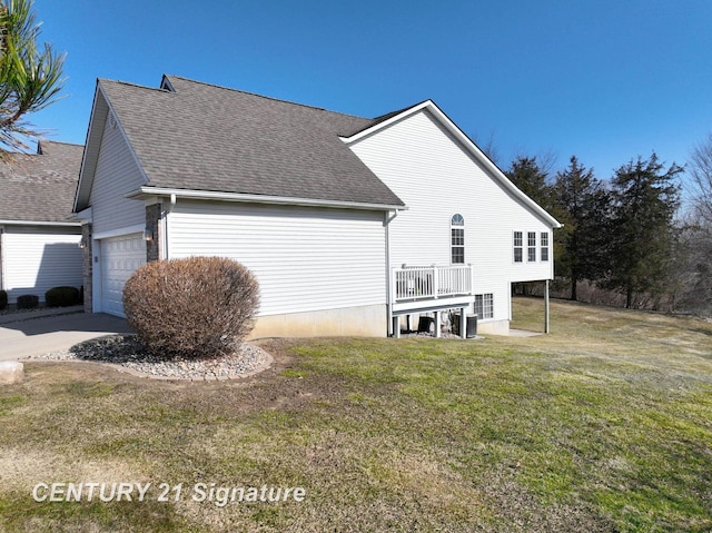 view of property exterior featuring a garage, a lawn, and roof with shingles