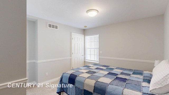 bedroom with carpet, visible vents, and baseboards