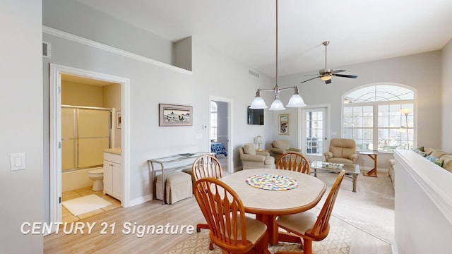 dining space featuring light wood-style floors, baseboards, visible vents, and ceiling fan