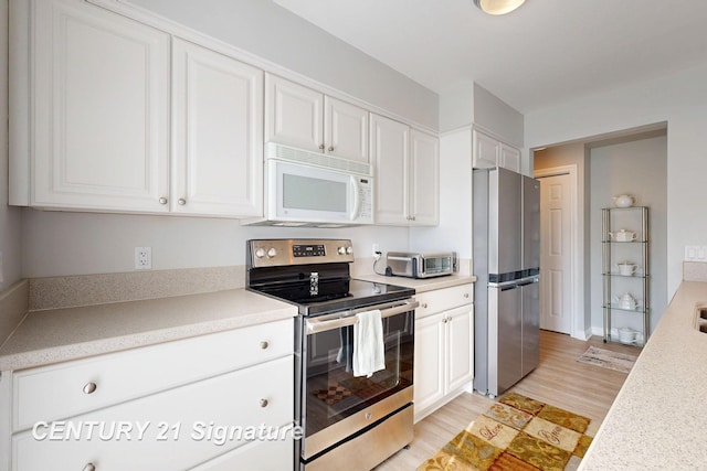 kitchen featuring white cabinetry, light countertops, and stainless steel appliances