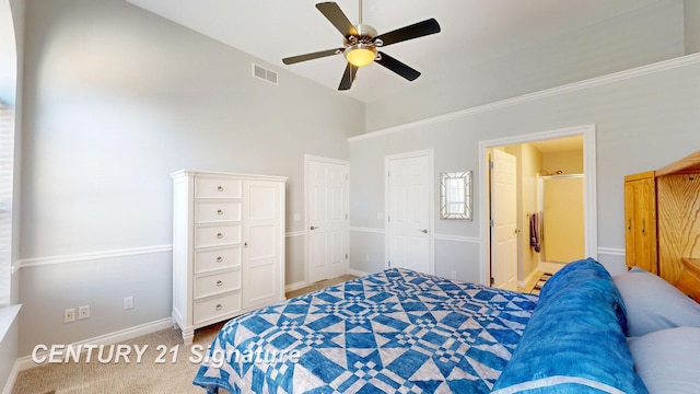 carpeted bedroom featuring ceiling fan, baseboards, visible vents, and connected bathroom