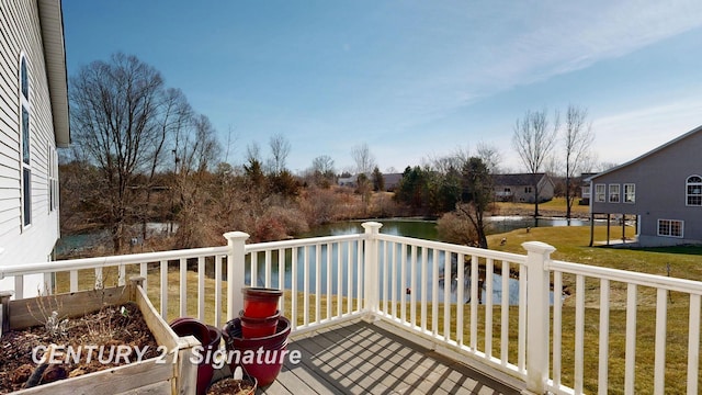 deck with a lawn and a water view