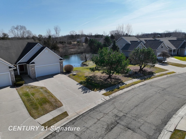 drone / aerial view featuring a water view and a residential view