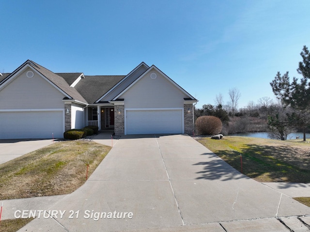 view of front of home with a front lawn, concrete driveway, and a garage