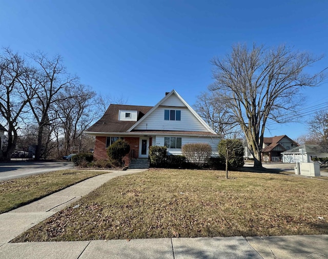 view of front of home featuring brick siding and a front lawn