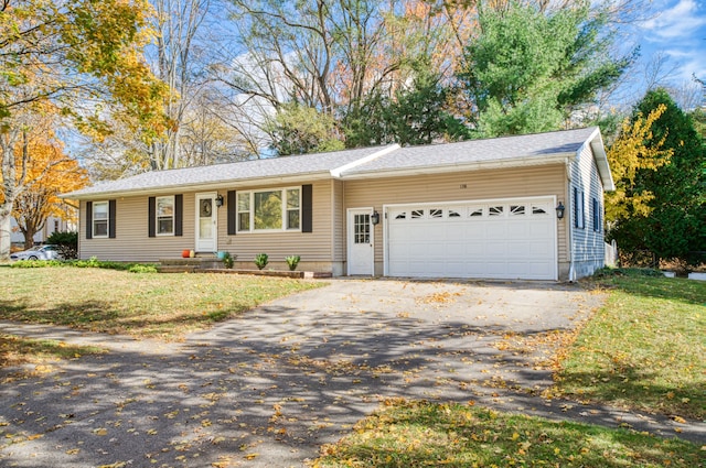 ranch-style house with aphalt driveway, a garage, and a front lawn