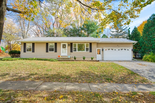 ranch-style house with driveway, a front lawn, and an attached garage