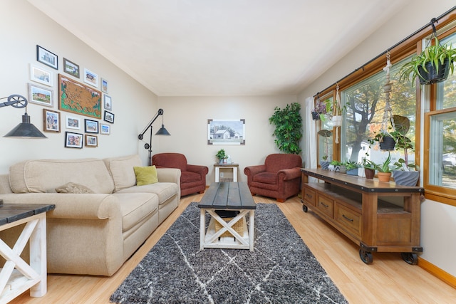 living room with baseboards and light wood-style flooring