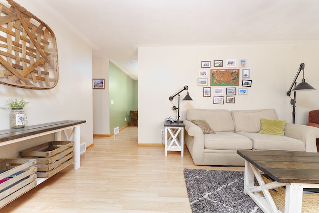 living room with baseboards and light wood-type flooring