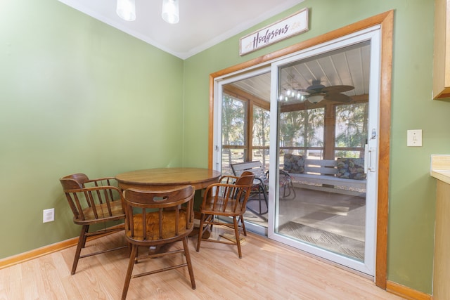 dining area with ceiling fan, baseboards, wood finished floors, and ornamental molding