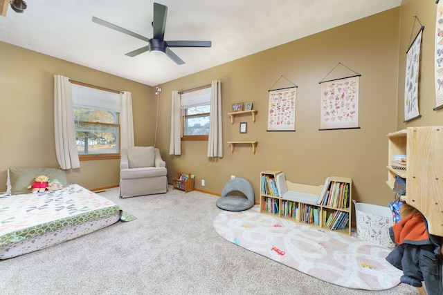 carpeted bedroom featuring a ceiling fan and baseboards