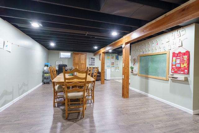 dining space featuring baseboards and wood finished floors