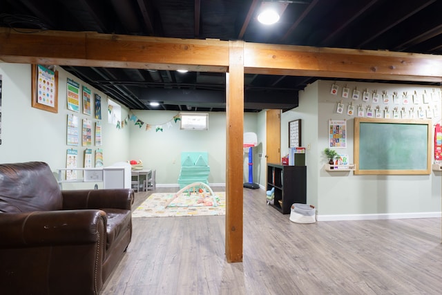 finished basement with baseboards and wood finished floors