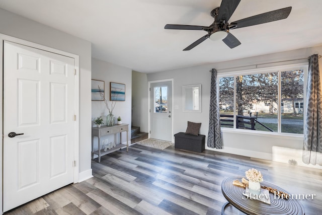 entryway featuring stairs, wood finished floors, and baseboards