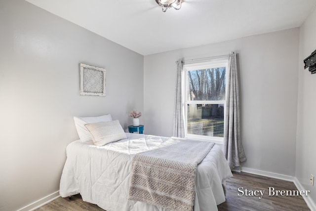 bedroom featuring baseboards and wood finished floors