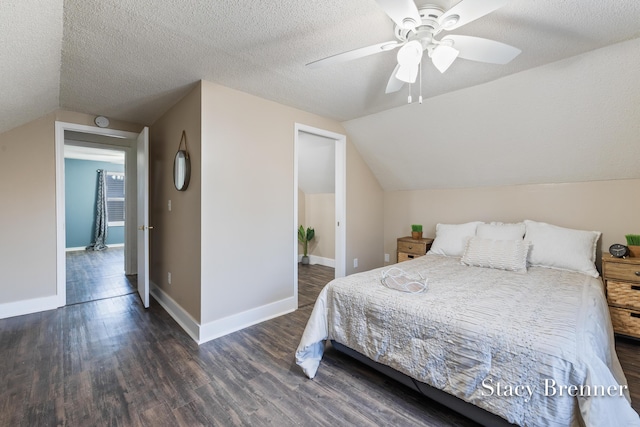 bedroom with baseboards, a textured ceiling, lofted ceiling, and wood finished floors