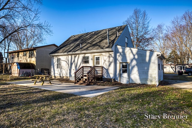 rear view of house with a patio area and a yard