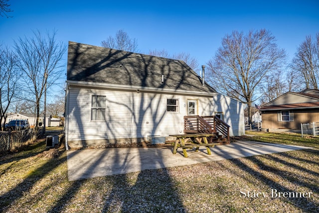 back of house featuring a patio area, a shingled roof, central AC, and fence