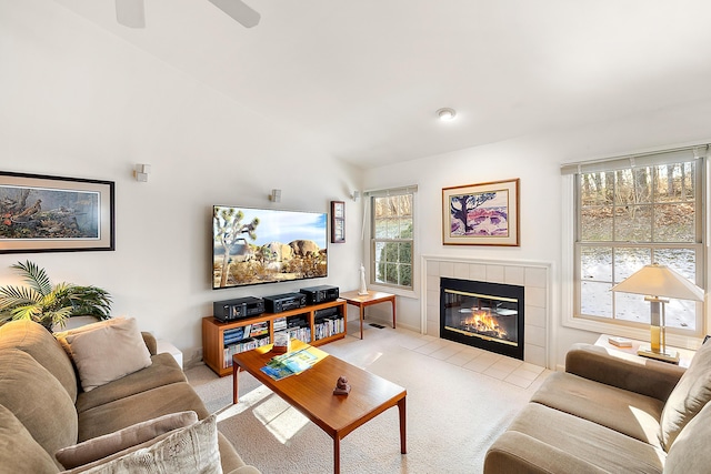 living area featuring carpet flooring and a tile fireplace