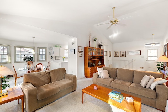 living room featuring light colored carpet, ceiling fan, and vaulted ceiling