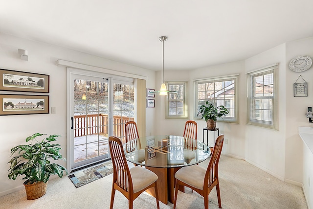 dining area with carpet flooring, baseboards, and a wealth of natural light