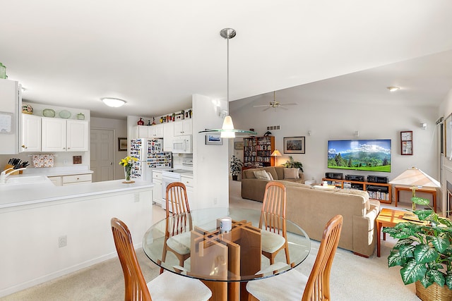 dining area featuring light colored carpet and ceiling fan