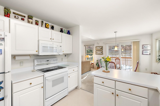 kitchen with white cabinetry, white appliances, light countertops, light colored carpet, and hanging light fixtures