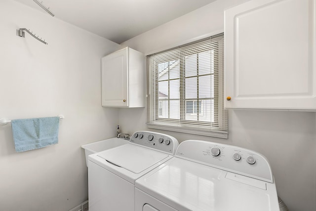 clothes washing area with cabinet space and washing machine and clothes dryer