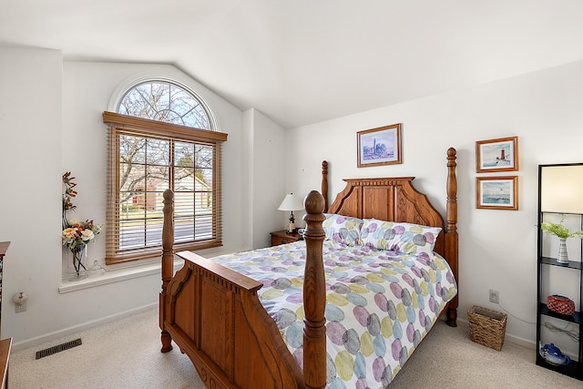 bedroom with visible vents, lofted ceiling, baseboards, and carpet flooring