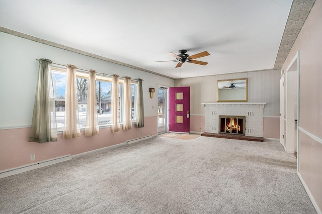 unfurnished living room featuring carpet floors, baseboard heating, a brick fireplace, and a ceiling fan