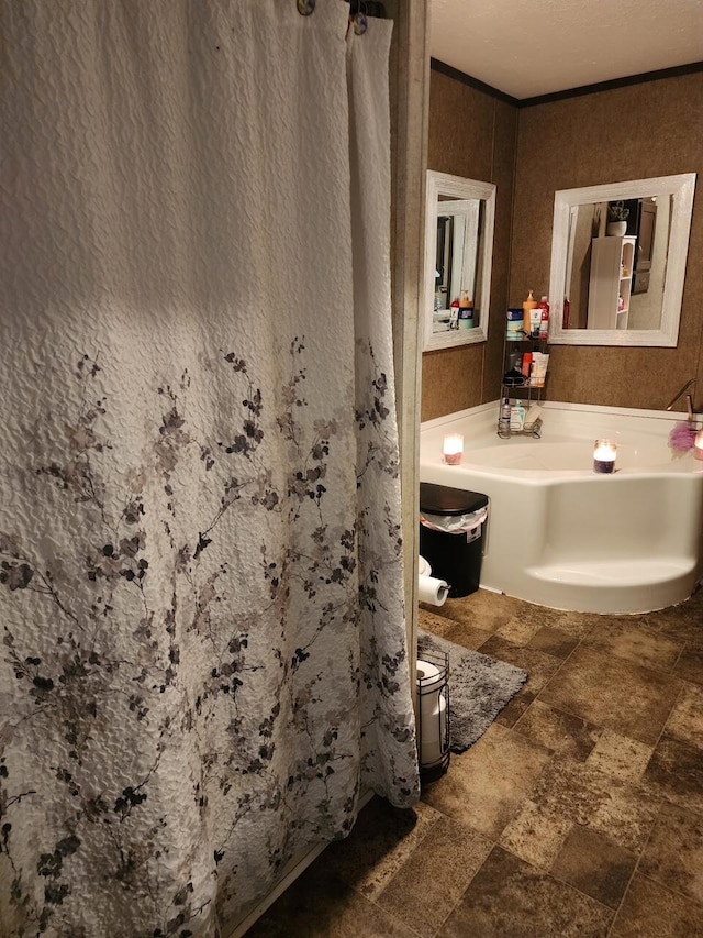 bathroom featuring crown molding and stone finish floor