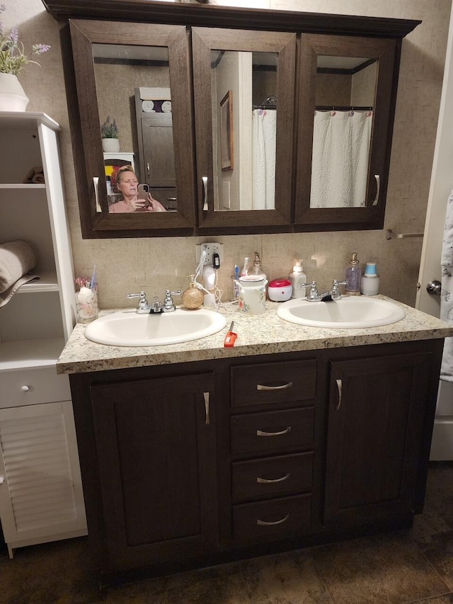 full bath with double vanity and a sink